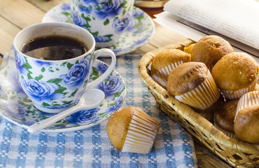 Cup of coffee, a muffin and the newspaper