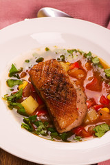 Spanish hot vegetable soup with duck breast. Rustic style. Toned image. Top view