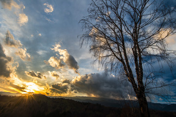 Fototapeta premium Autumn scenery in remote rural area in Transylvania and dramatic cloudy sky