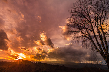 Naklejka na ściany i meble Autumn scenery in remote rural area in Transylvania and dramatic cloudy sky