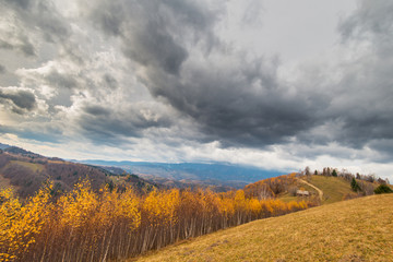 Fototapeta na wymiar Autumn scenery in remote rural area in Transylvania and dramatic cloudy sky