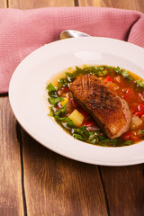 Spanish hot vegetable soup with duck breast. Rustic style. Toned image. Top view