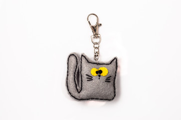 Felt handmade cat. Keychain on the white background.