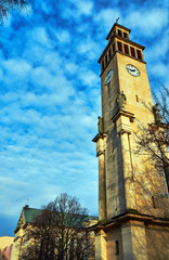 Fototapeta na wymiar Neoclassical campanile with statues and clock in Poznan.