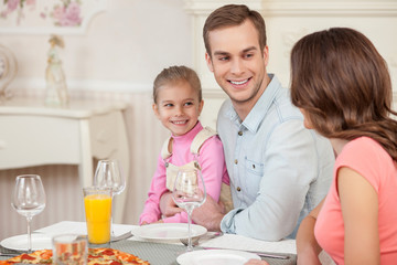 Cheerful married couple and child have a lunch