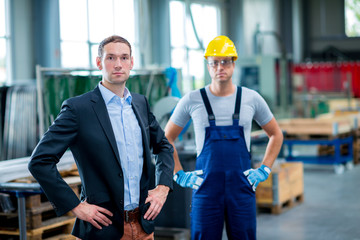 young boss with worker in his factory