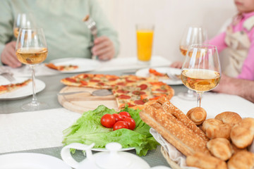 Cheerful relatives are dining together with joy