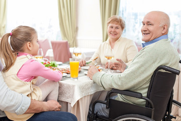 Obraz premium Cute friendly family is dining in restaurant