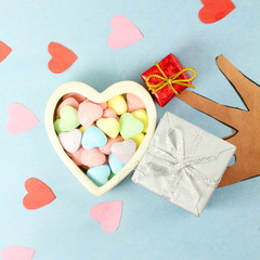 wooden Hearts with candy Valentine Background with red rose and happy valentine text in old wooden background