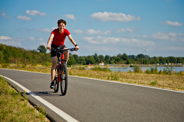 Urban biking - teenage boy riding bike