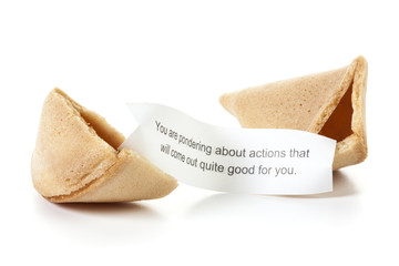 Fortune cookie with positive message isolated. Broken fortune cookie, message slip predicting positive future