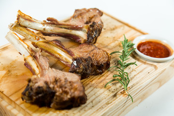 Close up view of Beautiful juicy barbecue ribs with sauce on a old wooden board