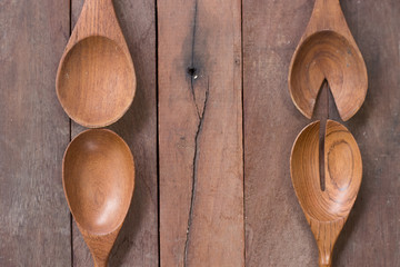 Various wooden spoons of wooden background