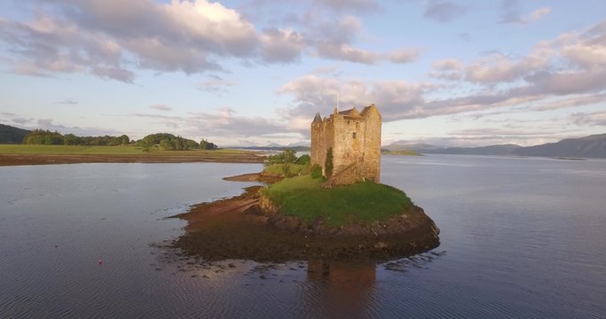 Aerial shot of Castle Stalker on the west coast of Scotland between Fort William and Oban in the morning with a sunset

