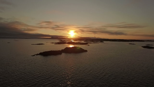 Aerial shot of the coast line on the west coast of Scotland during sunsey near Arisaig with Rum and Eigg in the background
