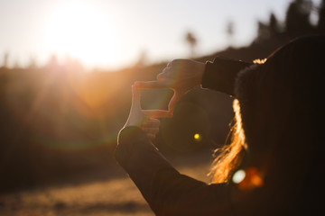 The woman hand framing distant.