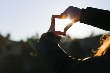 The woman hand framing distant.