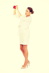 Shocked businesswoman looking into her empty wallet