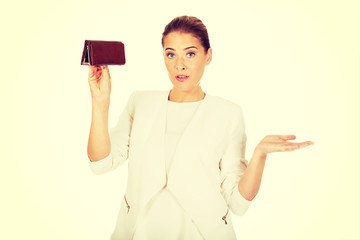 Young businesswoman holds empty wallet