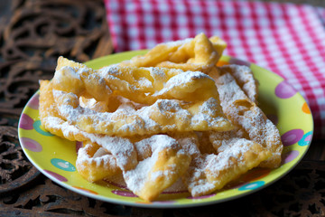 Flancat- crisp deep fried pastry dusted with powdered sugar.