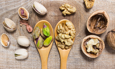 Closeup of a walnut and pistachios.