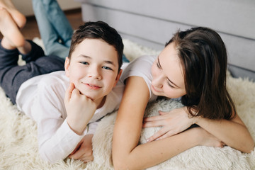 Brother and sister laughing together at home