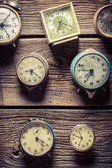Vintage clocks on the wooden wall
