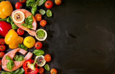 Raw salmon steaks and fresh ingredients for cooking. Frame