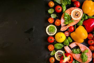 Raw salmon steaks and fresh ingredients for cooking. Frame