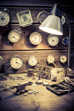 Old watchmaker's workshop with damaged clocks