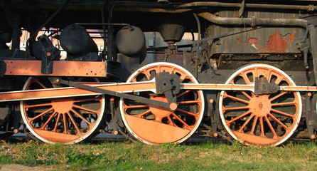 Fototapeta na wymiar Three wheels of an old steam locomotive