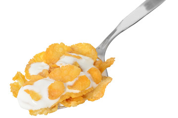 corn flakes in a spoon with yogurt
