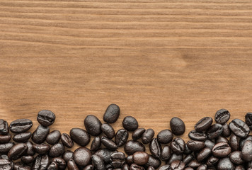 background of brown coffee beans on wood board