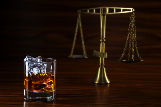 whiskey  and blurred scales of justice, concept alcohol and law