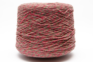 The cone of colored wool thread on a white background