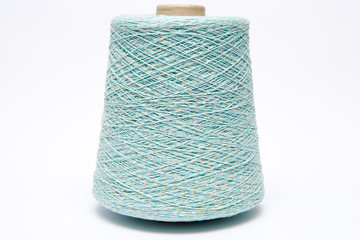 The cone of colored wool thread on a white background