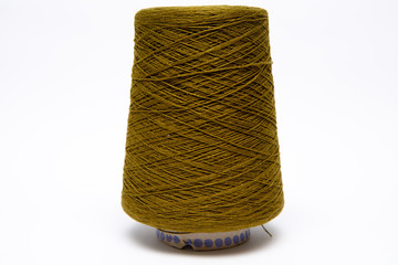 The cone of colored wool thread on a white background