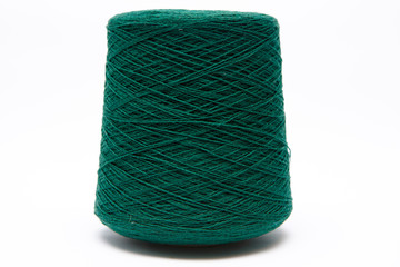 The cone of colored wool thread on a white background