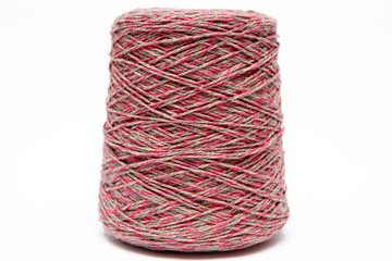 The cone of colored wool thread on a white background