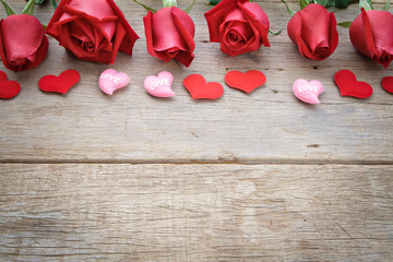 Roses with red and pink heart on wooden background. Valentine's day.