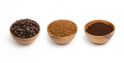 Preparing roasted coffee beans, granulated coffee and coffee powder in wooden bowl.