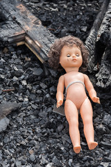 Old toy doll in the midst of ruins and devastation