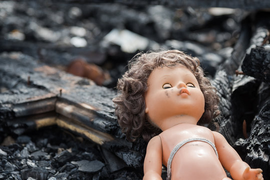 Old toy doll in the midst of ruins and devastation