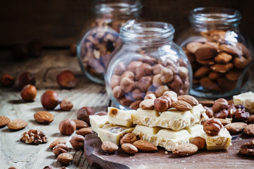 White chocolate with nuts assortment: almonds, hazelnuts, walnut