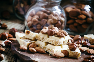 White chocolate with nuts assortment: almonds, hazelnuts, walnut