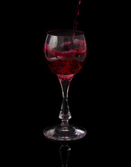 red wine pouring into a glass
