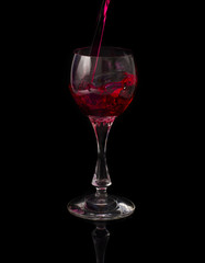 red wine pouring into glass