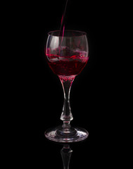 red wine pouring into glass