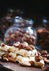White chocolate with nuts assortment: almonds, hazelnuts, walnut