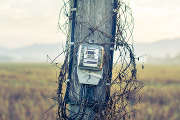 Old electricity post in countryside, vintage filter